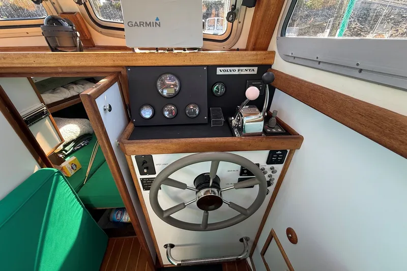 Slide: The Image of Mitchell Sea Angler 2002 boat cockpit with Garmin navigation and Volvo Penta controls. - 9