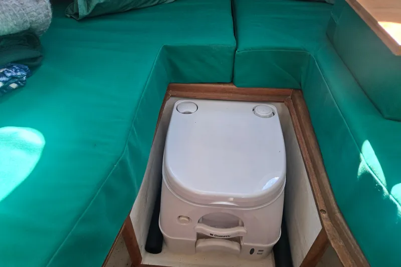 Slide: The Image of Compact marine toilet on a 2002 Mitchell Sea Angler boat with green seating. - 15