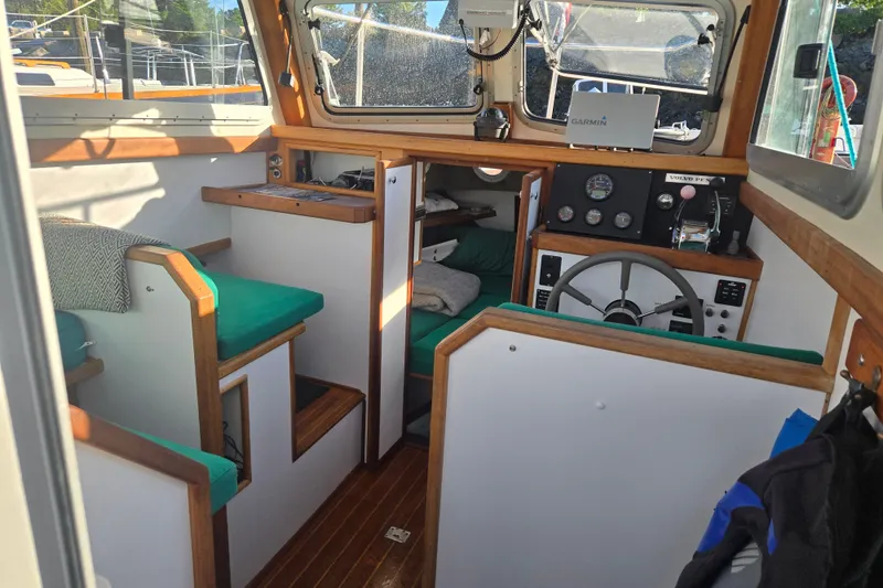 Slide: The Image of Interior of a 2002 Mitchell Sea Angler boat with wooden accents and green seating. - 12