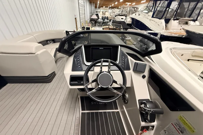 Slide: The Image of 2025 Sylvan G3 CLZ DC boat interior with modern steering and dashboard controls. - 12