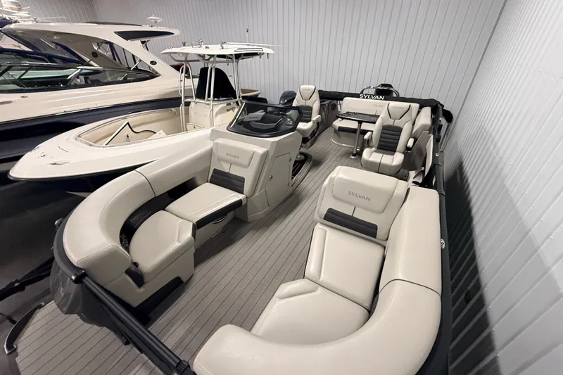 Slide: The Image of 2025 Sylvan G3 CLZ DC pontoon boat with luxurious seating in a showroom. - 8