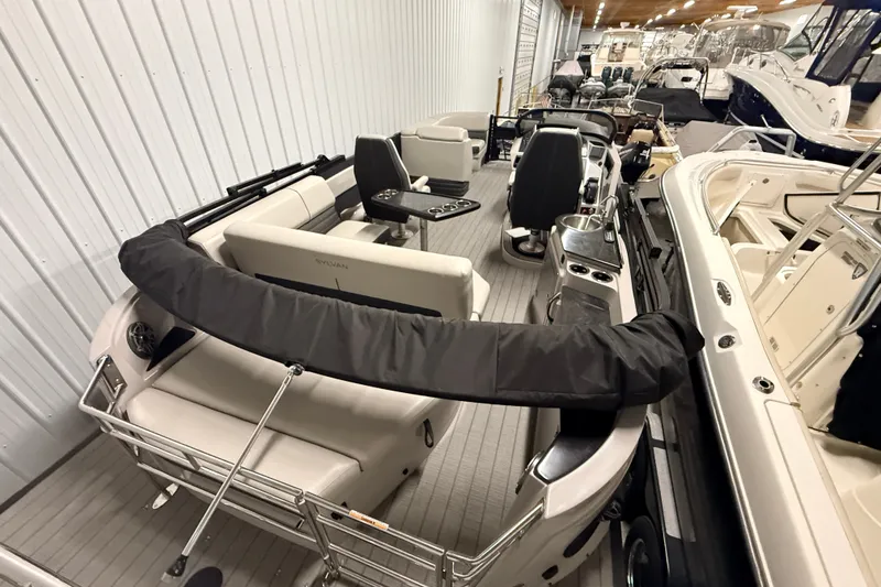 Slide: The Image of 2025 Sylvan G3 CLZ DC boat interior in showroom, featuring seating and control console. - 20