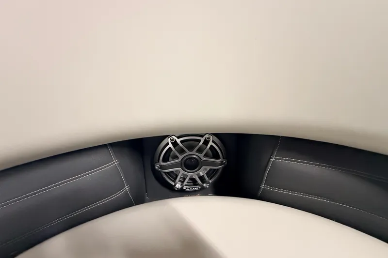 Slide: The Image of 2025 Sylvan G3 CLZ DC boat interior with speaker and cushioned seating. - 27