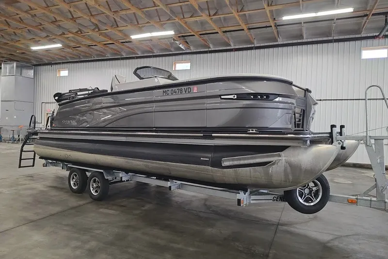 The Image of 2025 Sylvan G3 CLZ DC pontoon boat on trailer in indoor storage facility. - 0