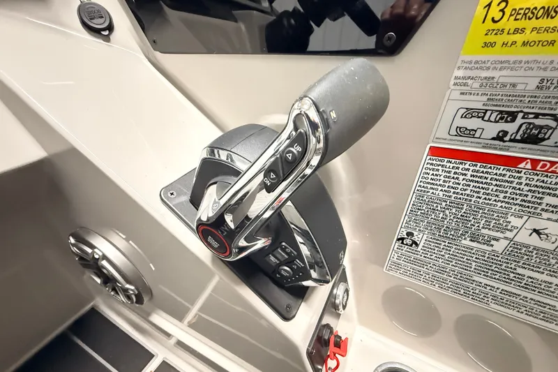 Slide: The Image of Control panel of 2025 Sylvan G3 CLZ DC boat with throttle lever and safety warnings. - 14