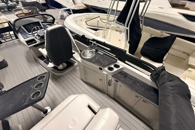 Slide: The Image of Interior of 2025 Sylvan G3 CLZ DC boat with helm, seating, and sink. - 22