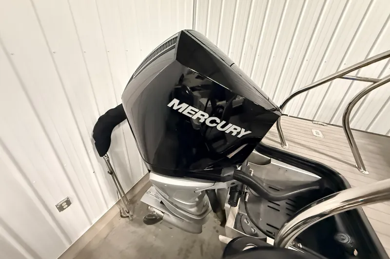 Slide: The Image of 2025 Sylvan G3 CLZ DC boat with Mercury outboard motor in a garage setting. - 18