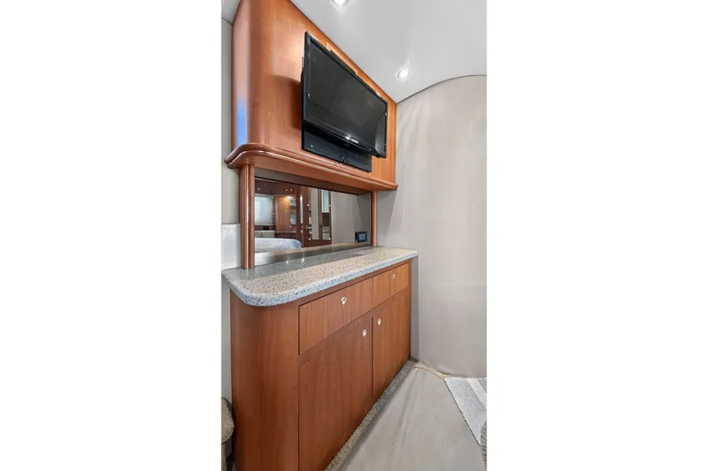 Slide: The Image of 2003 Cruisers Yachts 4450 Express Motoryacht interior with TV and wooden cabinetry. - 50