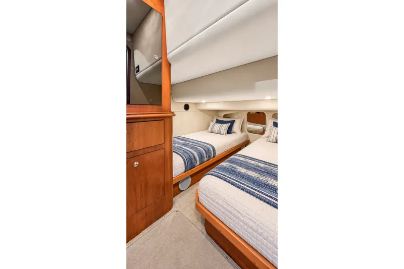 Slide: The Image of Interior cabin of 2003 Cruisers Yachts 4450 Express Motoryacht with twin beds and wooden cabinetry. - 44
