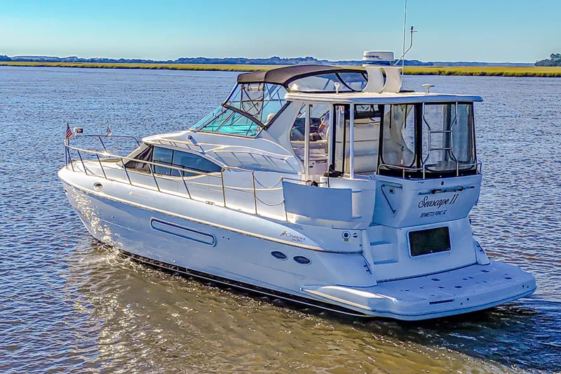 Slide: The Image of 2003 Cruisers Yachts 4450 Express Motoryacht cruising on open water. - 4