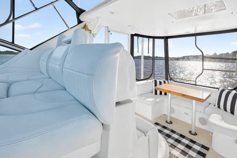 Slide: The Image of Luxurious interior of 2003 Cruisers Yachts 4450 Express Motoryacht with plush seating and scenic water view. - 15