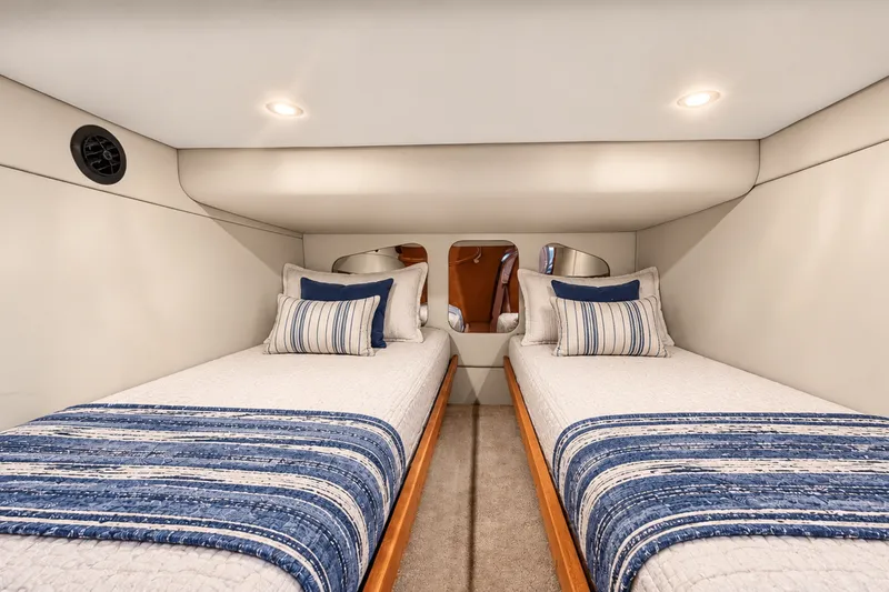 Slide: The Image of Interior cabin of 2003 Cruisers Yachts 4450 Express Motoryacht with twin beds and striped bedding. - 46