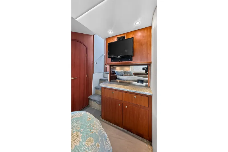 Slide: The Image of Luxurious interior of 2003 Cruisers Yachts 4450 Express Motoryacht with TV and cabinetry. - 49