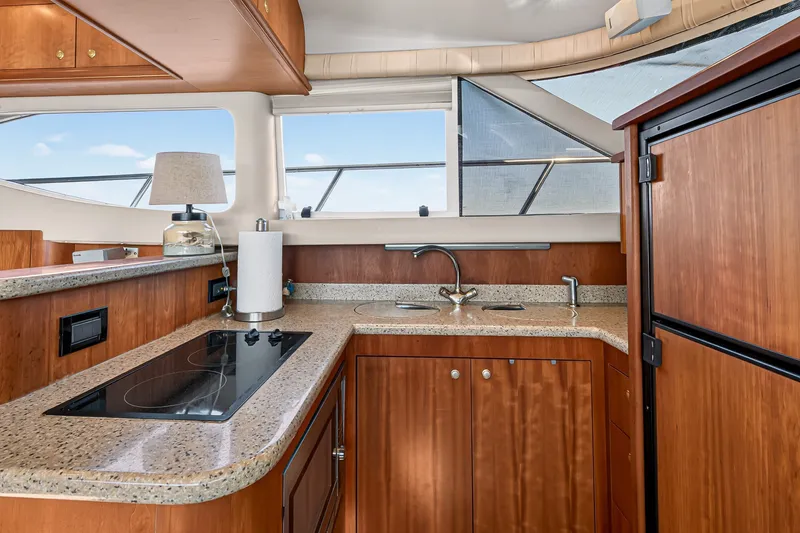 Slide: The Image of Luxurious 2003 Cruisers Yachts 4450 Express Motoryacht kitchen with modern amenities and sleek design. - 37