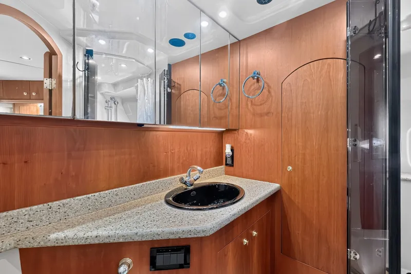 Slide: The Image of Luxurious bathroom in 2003 Cruisers Yachts 4450 Express Motoryacht with wood cabinetry and modern fixtures. - 58