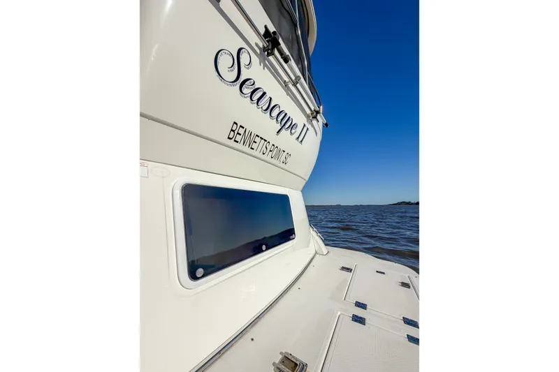 Slide: The Image of 2003 Cruisers Yachts 4450 Express Motoryacht on water, rear view with clear sky. - 6