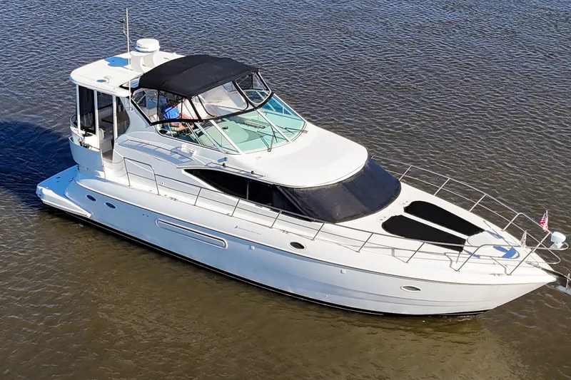 Slide: The Image of 2003 Cruisers Yachts 4450 Express Motoryacht on calm water, aerial view. - 0