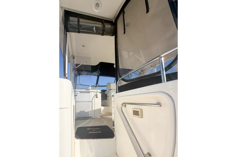 Slide: The Image of 2003 Cruisers Yachts 4450 Express Motoryacht interior with welcome mat and seating area. - 8