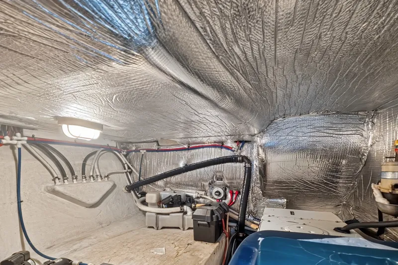 Slide: The Image of Mechanical room of 2003 Cruisers Yachts 4450 Express Motoryacht with insulation and mechanical components. - 68