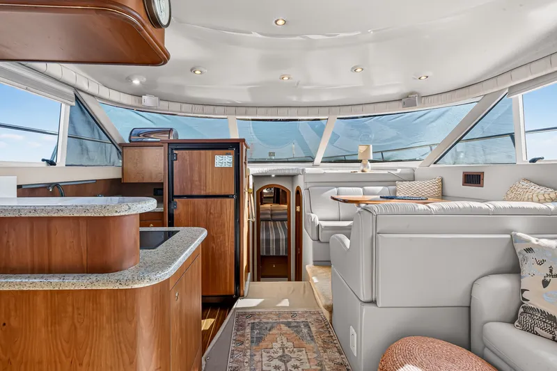 Slide: The Image of Luxurious 2003 Cruisers Yachts 4450 Express Motoryacht interior with elegant seating and modern amenities. - 27