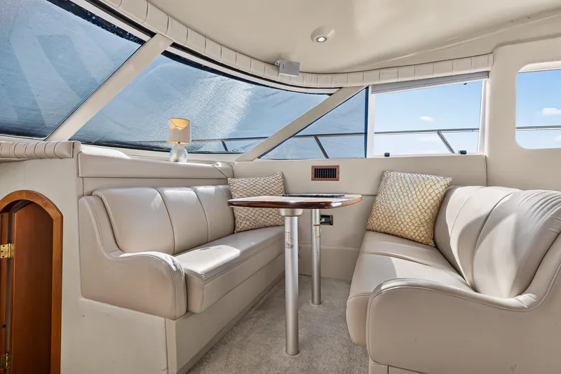Slide: The Image of Luxurious interior of 2003 Cruisers Yachts 4450 Express Motoryacht with plush seating and table. - 34
