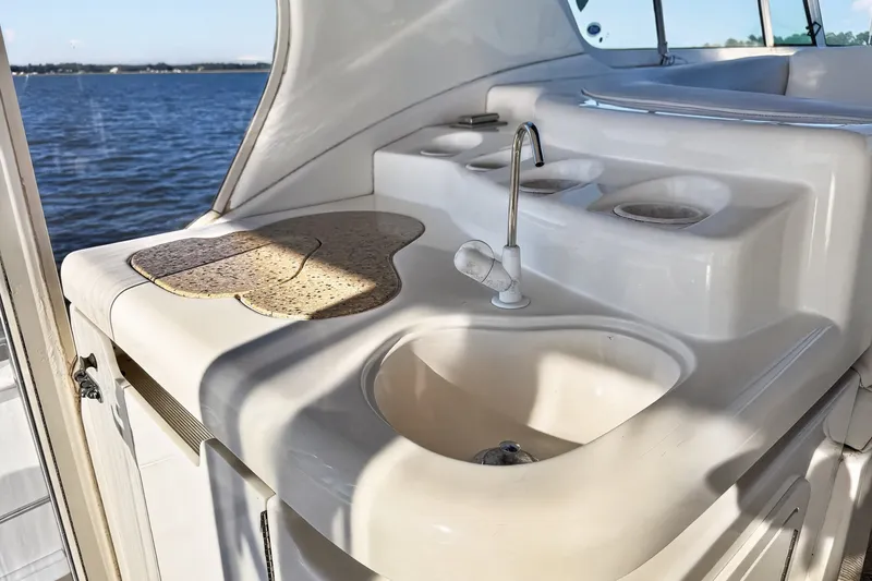 Slide: The Image of 2003 Cruisers Yachts 4450 Express Motoryacht sink area with ocean view. - 14