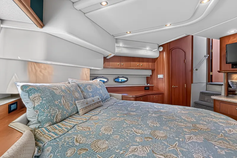 Slide: The Image of Luxurious bedroom interior of 2003 Cruisers Yachts 4450 Express Motoryacht with elegant bedding. - 54