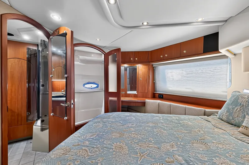 Slide: The Image of Luxurious interior of 2003 Cruisers Yachts 4450 Express Motoryacht bedroom with elegant wood finishes. - 52