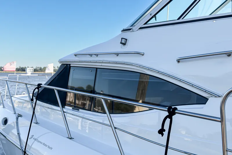 Slide: The Image of 2003 Cruisers Yachts 4450 Express Motoryacht docked, showcasing sleek design and windows. - 22