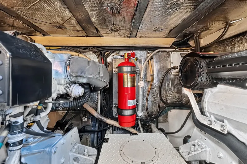 Slide: The Image of Engine room of 2003 Cruisers Yachts 4450 Express Motoryacht with fire extinguisher and machinery. - 66