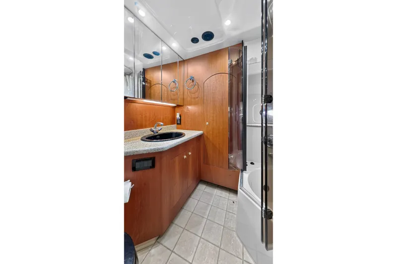 Slide: The Image of Luxurious bathroom in 2003 Cruisers Yachts 4450 Express Motoryacht with wood cabinetry. - 56