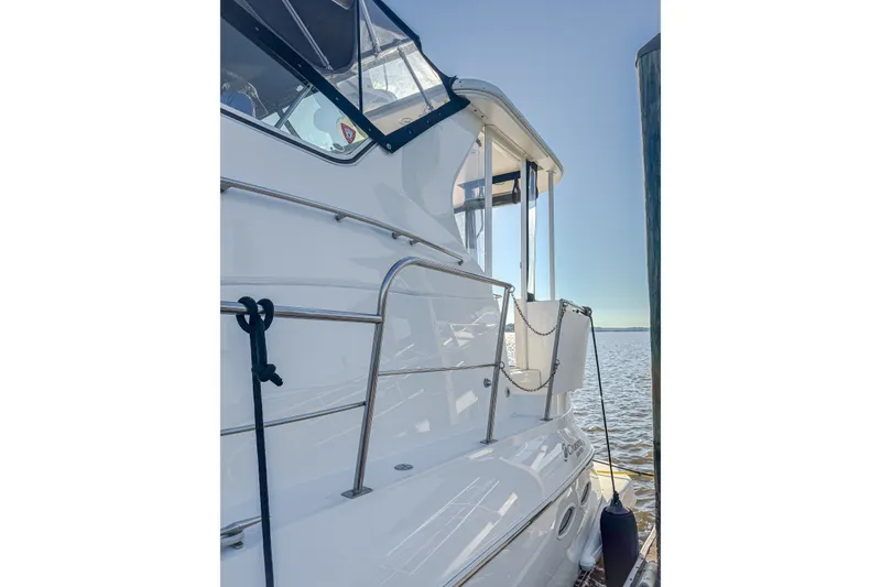 Slide: The Image of 2003 Cruisers Yachts 4450 Express Motoryacht docked by the water. - 20