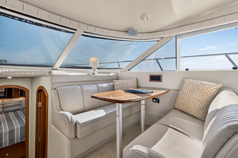 Slide: The Image of Luxurious interior of 2003 Cruisers Yachts 4450 Express Motoryacht with elegant seating and table. - 33