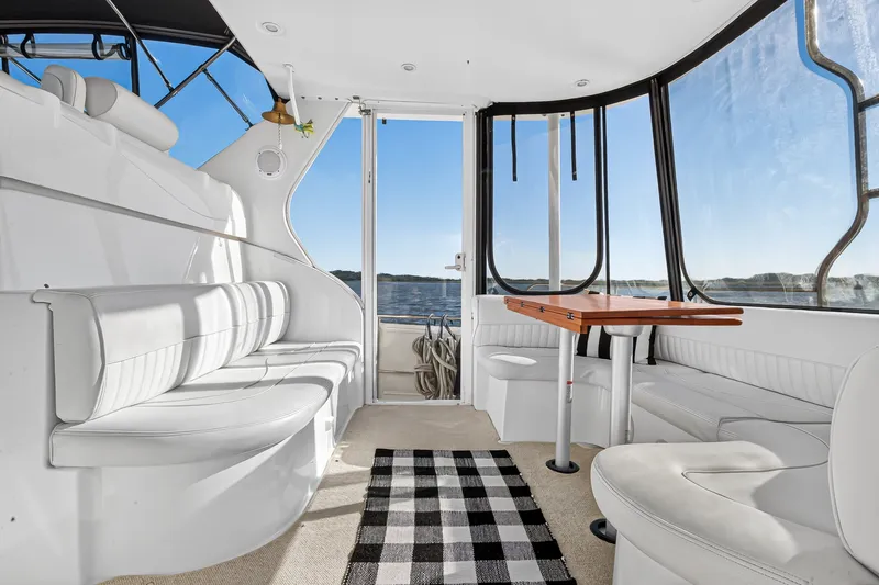 Slide: The Image of Luxurious interior of 2003 Cruisers Yachts 4450 Express Motoryacht with panoramic windows and seating. - 11