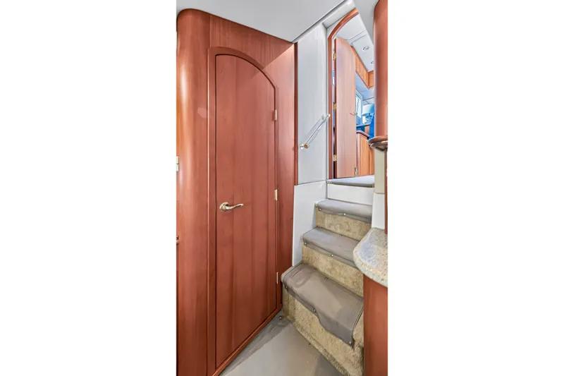 Slide: The Image of Interior staircase of 2003 Cruisers Yachts 4450 Express Motoryacht with wooden doors. - 47