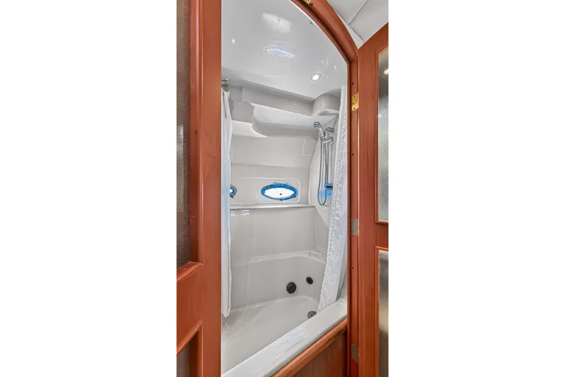 Slide: The Image of Luxurious bathroom Jacuzzi Tub behind French Doors in Master Stateroom of 2003 Cruisers Yachts 4450 Express Motoryacht - 60