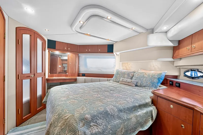 Slide: The Image of Luxurious bedroom interior of 2003 Cruisers Yachts 4450 Express Motoryacht with elegant wood finishes. - 51