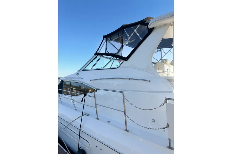Slide: The Image of 2003 Cruisers Yachts 4450 Express Motoryacht, side view with clear blue sky. - 21