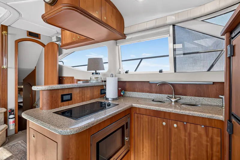 Slide: The Image of Luxurious kitchen interior of 2003 Cruisers Yachts 4450 Express Motoryacht with modern amenities. - 36