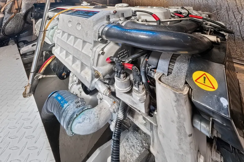 Slide: The Image of Engine compartment of a 2003 Cruisers Yachts 4450 Express Motoryacht, showcasing mechanical components. - 64