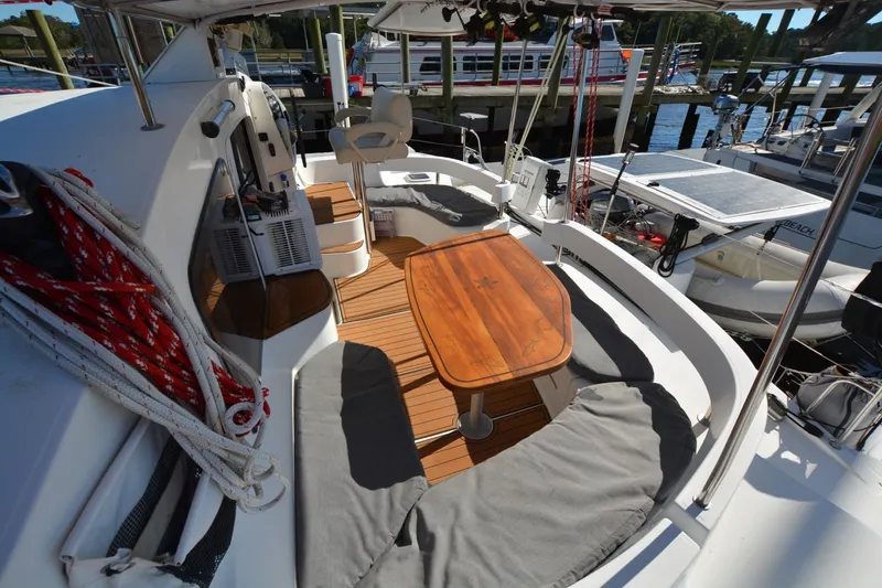 Slide: The Image of 2006 Fountaine Pajot LAVEZZI 40 catamaran deck with seating and wooden table. - 17