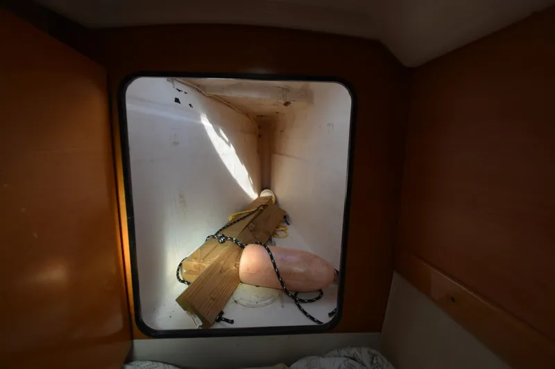 Slide: The Image of Storage compartment inside 2006 Fountaine Pajot LAVEZZI 40 catamaran with wooden planks and buoy. - 44