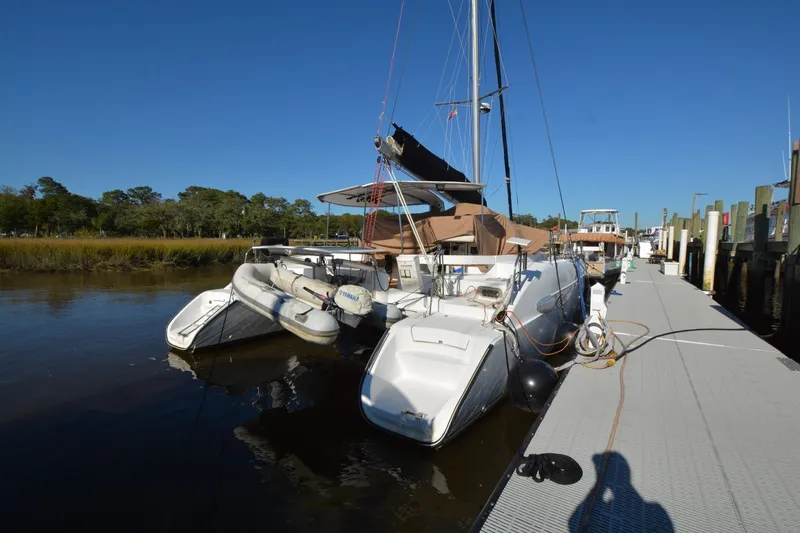 Slide: The Image of 2006 Fountaine Pajot LAVEZZI 40 catamaran docked at marina under clear blue sky. - 5