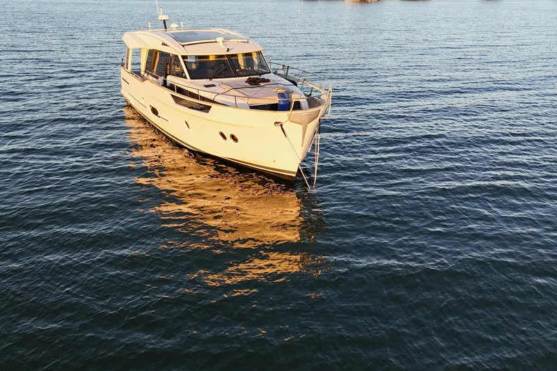 The Image of 2019 Greenline 48 Coupe yacht on calm water at sunset. - 0