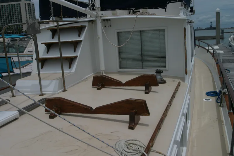 Slide: The Image of 1979 Grand Banks 42 Classic yacht deck with wooden details and docked at marina. - 4