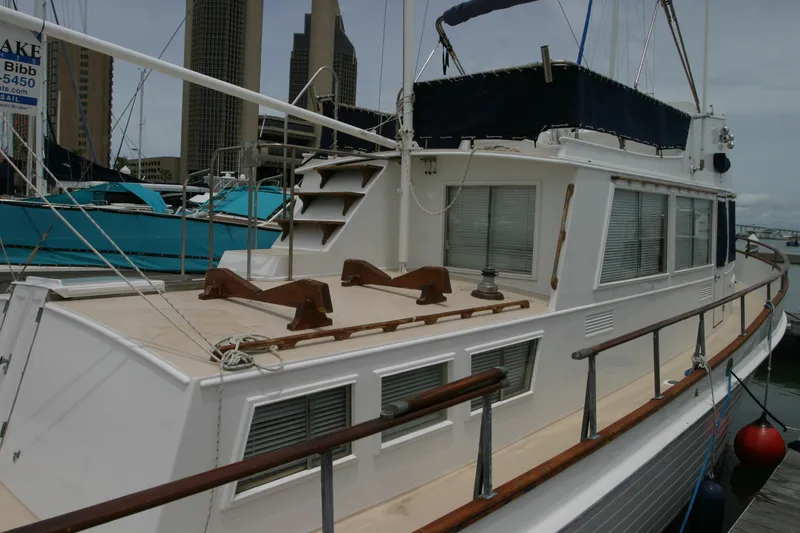 Slide: The Image of 1979 Grand Banks 42 Classic yacht docked at a marina, showcasing its elegant design. - 3