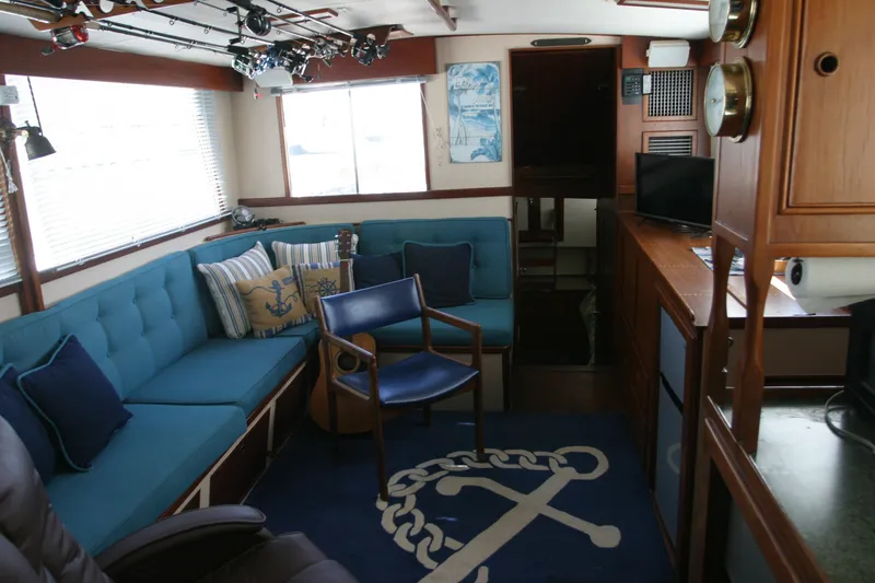 Slide: The Image of Interior of a 1979 Grand Banks 42 Classic yacht with blue seating and nautical decor. - 9