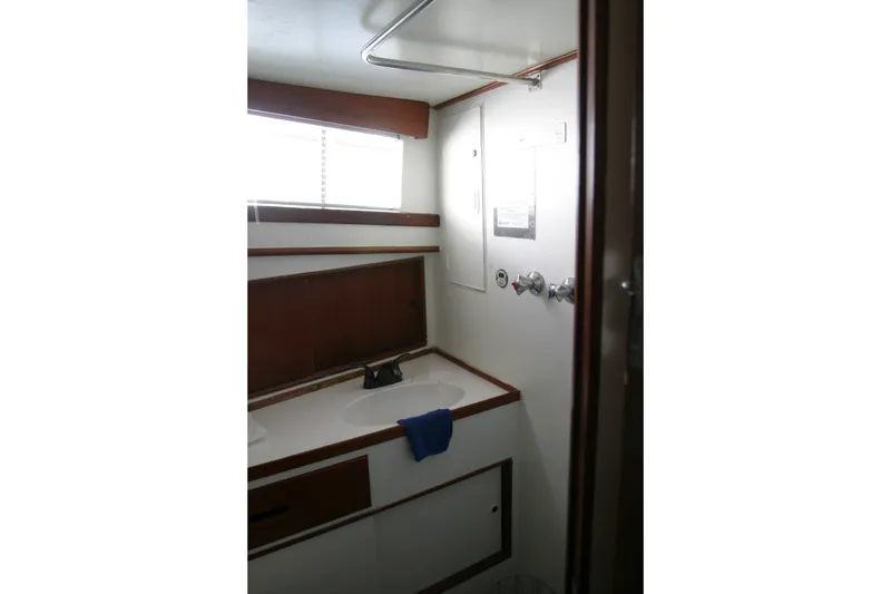 Slide: The Image of 1979 Grand Banks 42 Classic yacht bathroom interior with sink and window. - 14