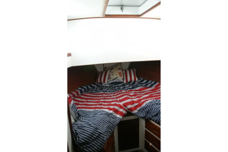 Slide: The Image of Cozy cabin interior of 1979 Grand Banks 42 Classic with striped bedding. - 15