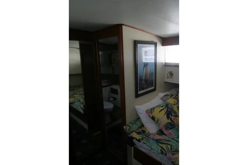 Slide: The Image of Interior cabin of 1979 Grand Banks 42 Classic with tropical bedding and framed artwork. - 17